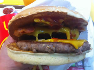 Mc Angus Bacon: 2 hambúrgueres de 100g de carne bovina de Angus, cheddar, temperos, cebola roxa, picles, bacon, mostarda e ketchup - Mc Donald`s